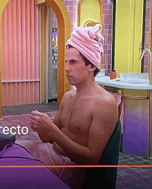 a shirtless man with a pink towel wrapped around his head sits in front of a directo logo