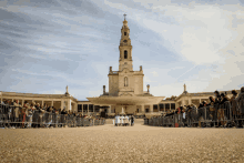 a group of people standing in front of a large church