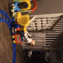 a child is playing with a toy train that has a smiley face on it