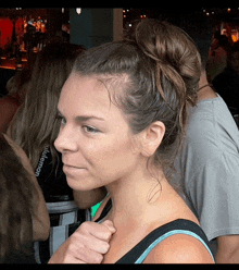 a woman wearing a lululemon shirt is standing in a crowd