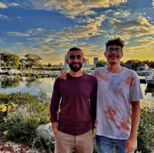 two men standing next to each other one wearing a champion shirt