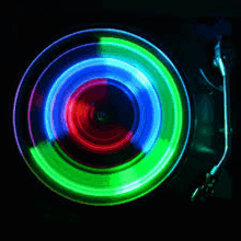 a record player is playing a record with a colorful light on it .