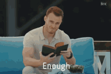 a man sitting on a couch reading a book with the word enough written above him