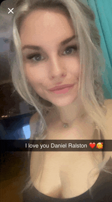 a woman taking a selfie with a message that says i love you daniel ralston