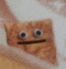 a close up of a cracker with googly eyes and a mustache .