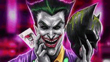 the joker is talking on a cell phone while holding a card and a batman mask .