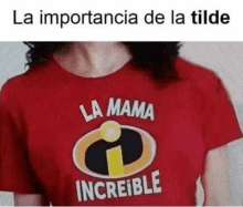 a woman wearing a red t-shirt that says `` la mama increible '' .