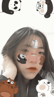 a girl with we bare bears stickers on her face looks at the camera