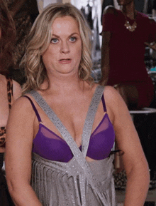 a woman in a purple bra and a gray dress