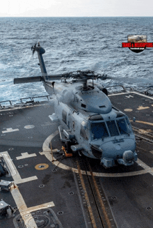 a helicopter is sitting on the deck of a ship with a logo for tanks & helicopters on the bottom