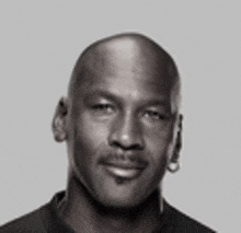 a black and white photo of michael jordan with a bald head and a beard .