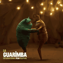 a poster for the la guarimba international film festival shows two monsters hugging