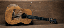 a guitar is sitting on a wooden bench with graffiti on it including one that says ' i love you ' on it