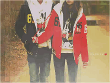 a couple wearing mickey mouse jackets with the number 6 on the front