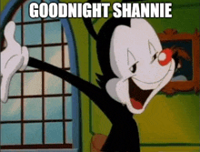 a cartoon character with a red nose says goodnight shannie in front of a window