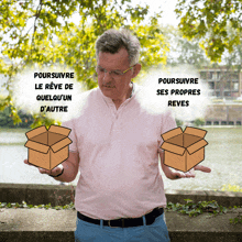 a man in a pink shirt is holding two cardboard boxes in front of a sign that says poursuivre