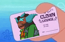 a person holding a clown license with a picture of a clown on it