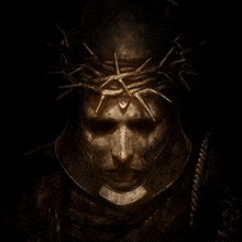 a man with a crown of thorns on his head is wearing a helmet .