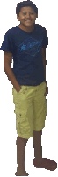 a young boy wearing a blue shirt and yellow shorts is standing with his hands in his pockets