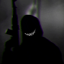 a silhouette of a person holding a gun with a smiling face on it