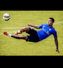 a soccer player wearing a blue shirt with the word ing on it