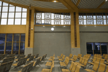 a waiting room with rows of chairs and a wall with chinese characters on it