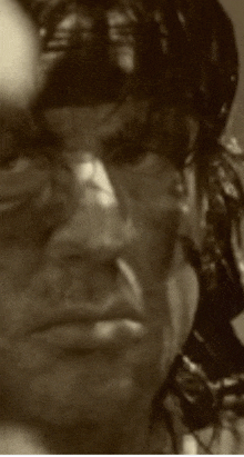 a close up of a man 's face with a blurry background