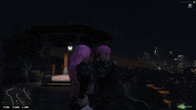 a woman with pink hair is hugging a man with black hair