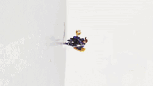 a purple robot with a sword is laying on its back on a white background