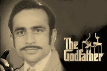 a man with a mustache and glasses is holding a cigar in front of the godfather logo .