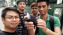 a group of young men are posing for a picture in front of a building that says terrace on it