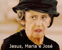 an elderly woman wearing a black hat with the words jesus maria e jose below her