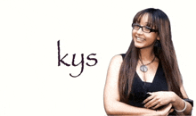 a woman wearing glasses is smiling in front of a white background with the word kys written on it