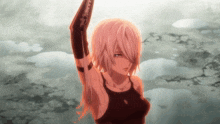 a girl in a black tank top holds her arm up