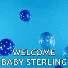 a bunch of blue balloons are flying in the air with the words `` welcome baby sterling `` written on them .