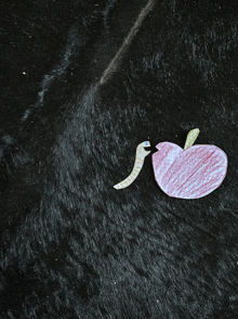 a drawing of an apple with a worm on it