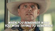 a man in a cowboy hat with the words " when you remember what you were trying to remember " below him