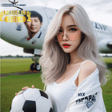 a woman holding a soccer ball in front of an airplane with museum bola written on it