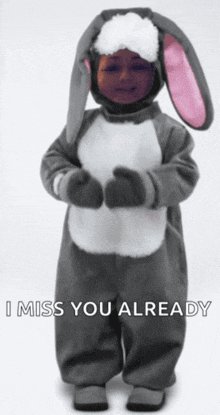 a child in a bunny costume with the words i miss you already