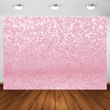 a room with a pink background and a wood floor