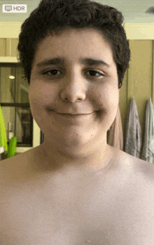 a shirtless boy is smiling in front of a screen that says " hdr "