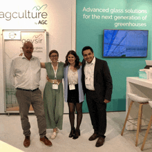 a group of people stand in front of a sign that says agculture