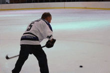 a hockey player in a jersey that says ' ice 's tribute ' on the back