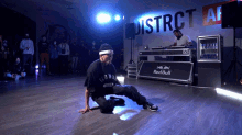 a man is kneeling on the floor in front of a red bull advertisement
