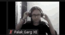 a woman wearing headphones is on a video call with the name palak garg xe