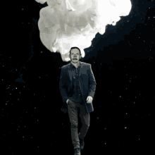 a man with a mustache is walking in front of a cloud of smoke