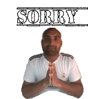 a man with his hands folded in front of a sign that says " sorry "