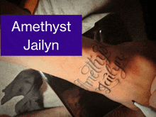 a person with amethyst jailyn tattoo on their arm