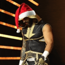 a man is wearing a santa hat and a boxing costume .