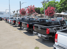 a row of silverado pickup trucks parked in a parking lot